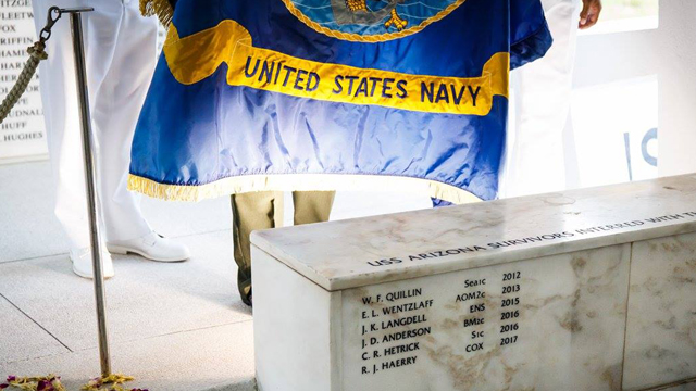 The USS Arizona Memorial wall with the names of the fallen soldiers inscribed on it.