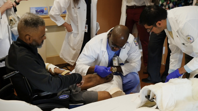 Winfred Lewis, a U.S. Army Veteran, receives wound care from the polytrauma medical team.
