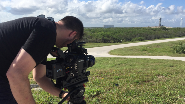 Director Adam White lines up a shot of the Kennedy Space Center