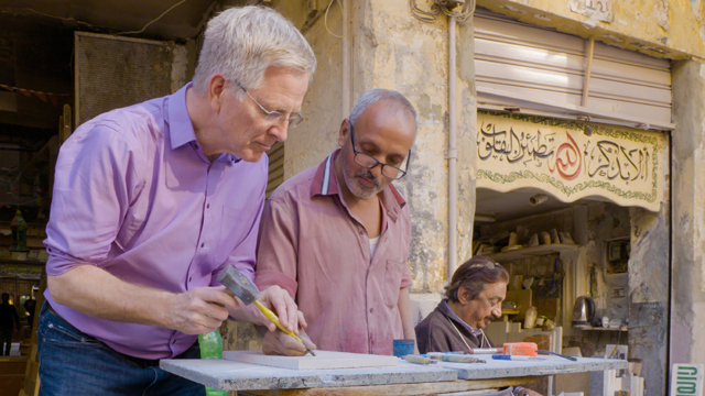 A Cairo artisan gives Rick a hands-on lesson in tombstone engraving